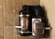 The pine tar soap bundle sit in a shower shelf.