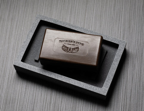 Pine tar bar soap in a black tray.